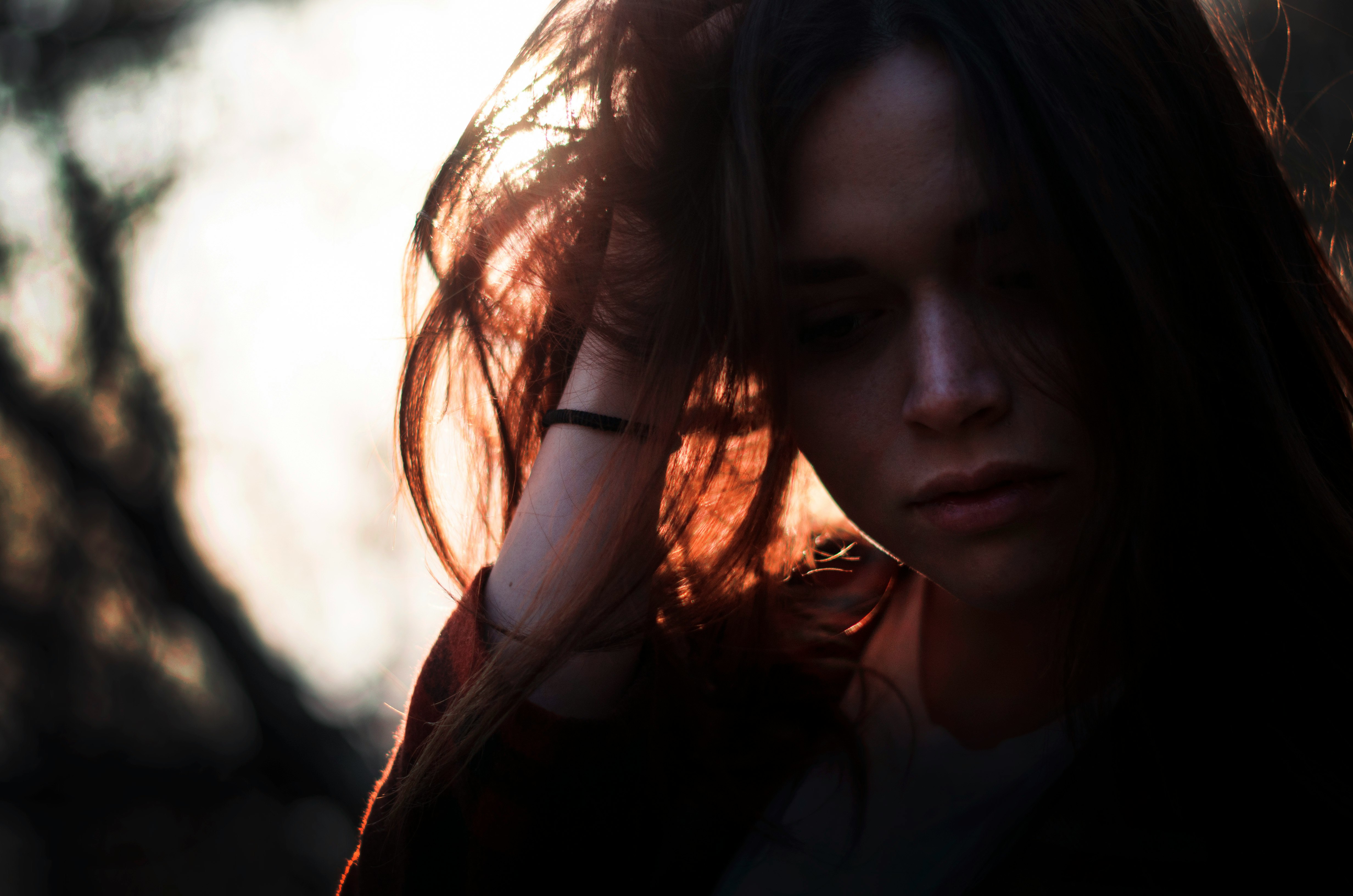 woman left hand on hair under sunset